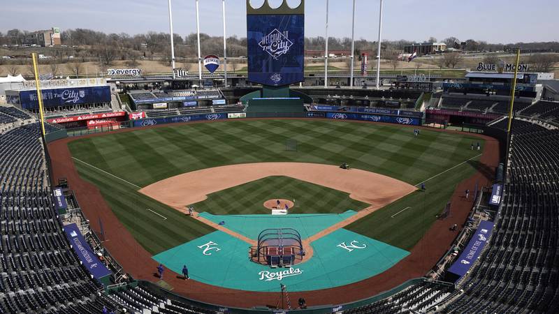 Members of the Kansas City Royals' grounds crew work off the field in preparation for the 2023...